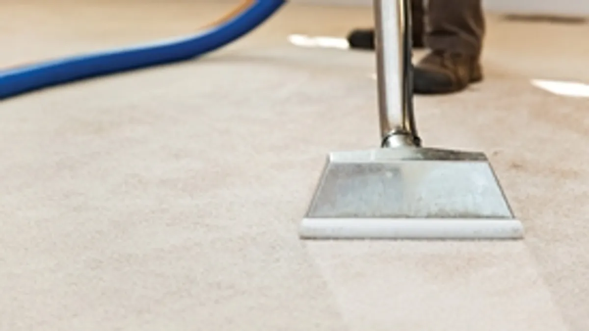 Carpet cleaning wand head gliding over a light carpet during hot-water extraction, Salt Lake City, UT.